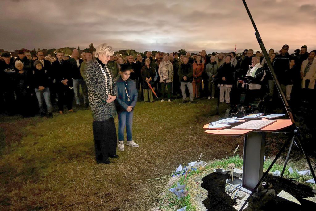 Burgemeester Schaap en kinderburgemeester Sleman Bargo bij het monument aan de Rijn